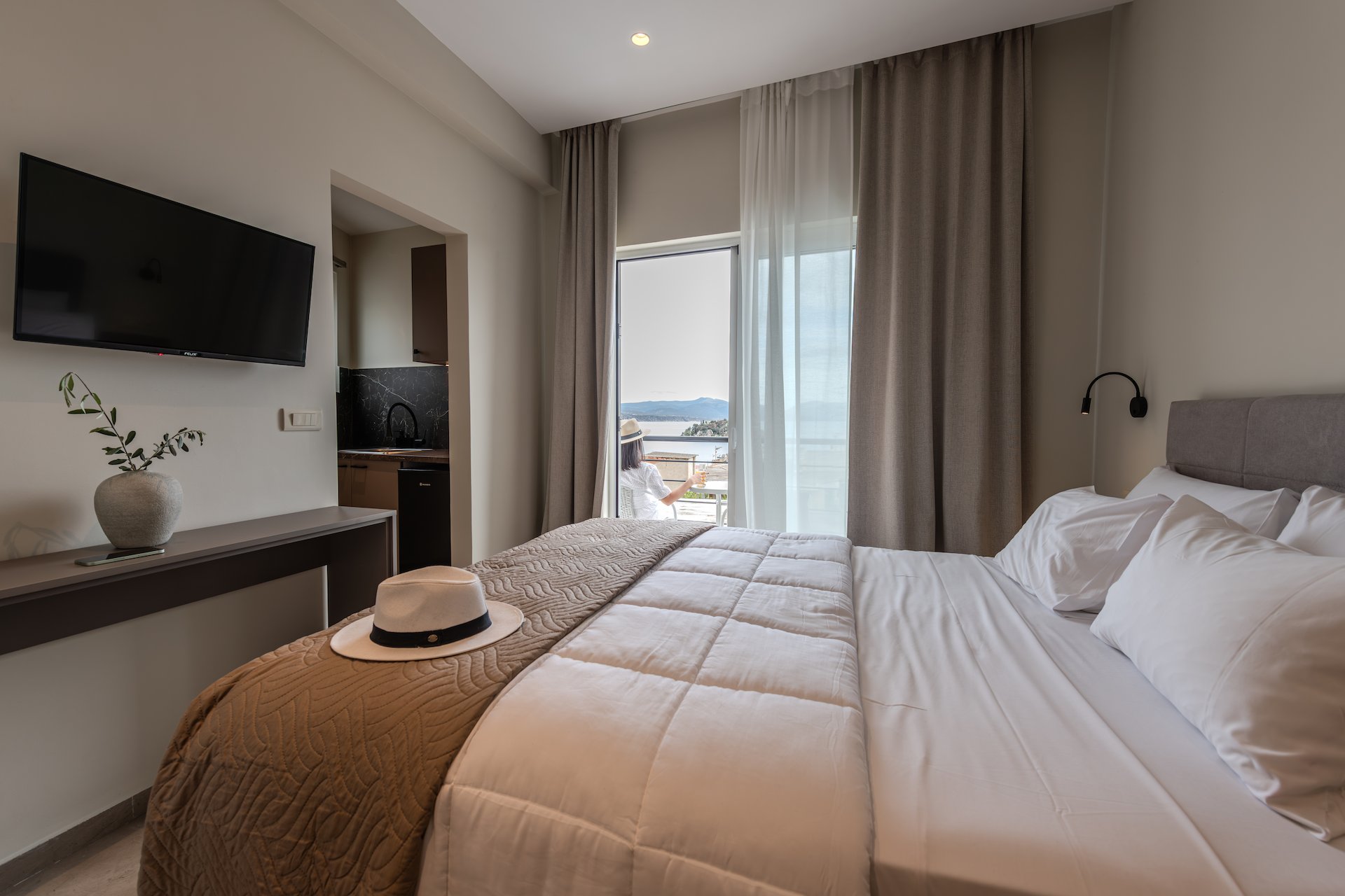 Deluxe Suite with Sea View - Serene minimalist interior and sea view at Noma Suites Tolo