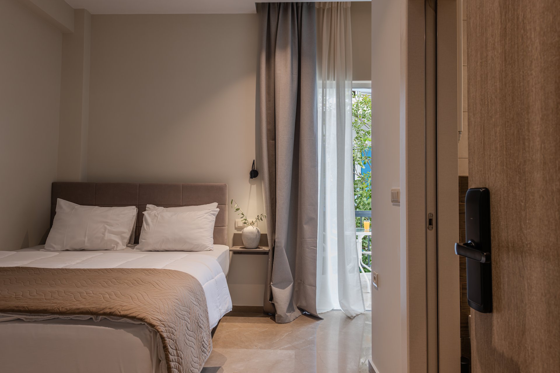 Superior Double Room with Garden View - Cozy room with garden balcony at Noma Suites Tolo